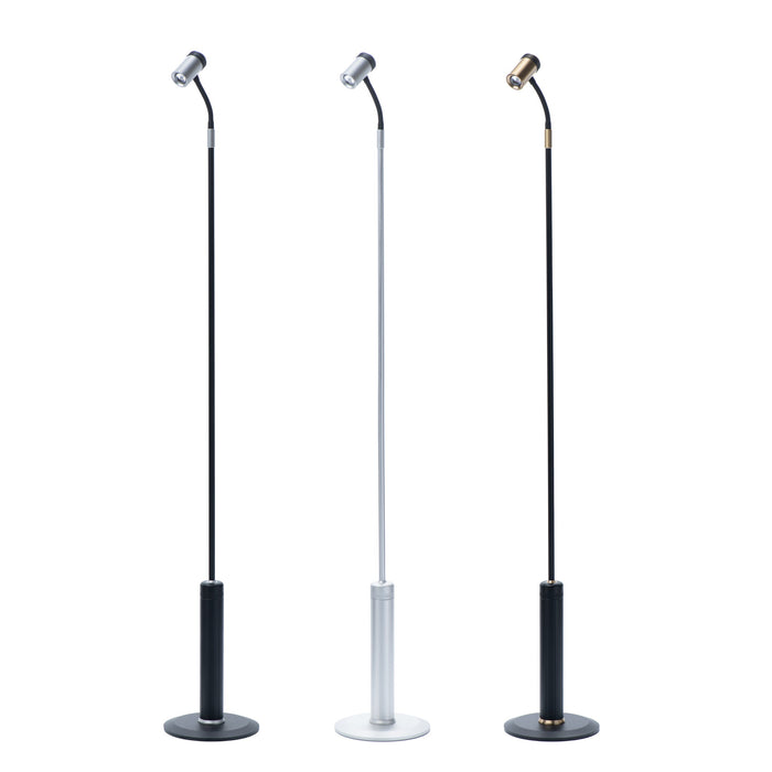 Set of three modern task floor lamps with adjustable gooseneck design, featuring black, silver, and brass finishes.