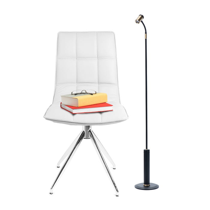 Sleek black LightBob Cordless LED Task Light next to a white chair, with adjustable neck for precise lighting in home settings.
