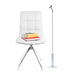 Cordless LightBob LED Task Light with adjustable neck, standing next to a contemporary white chair with books, for focused illumination.