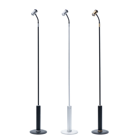 Set of three modern task floor lamps with adjustable gooseneck design, featuring black, silver, and brass finishes.